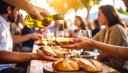Golden olive oil drizzled on crusty bread during an outdoor Mediterranean feast