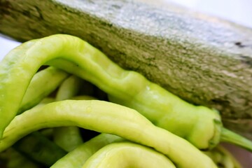 Fresh green zucchini and colorful peppers arranged together, showcasing natural texture and vibrant colors, ideal for concepts related to healthy eating, fresh produce, and organic farming.