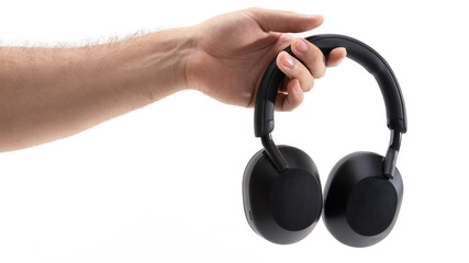 Hand holding black wireless headphones