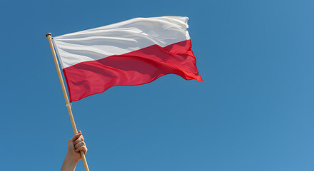 Polish Flag Waving in Clear Blue Sky