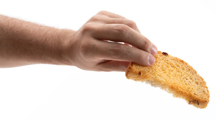 Hand holding a piece of golden bread slice