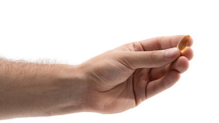 Hand with soft gel capsule ready to take