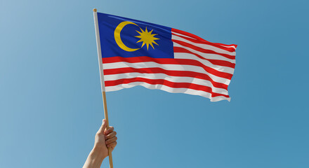 Malaysian Flag Waving Proudly Against a Clear Blue Sky