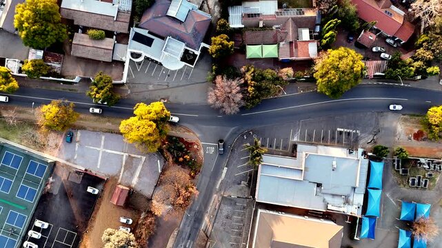 T-junction traffic stop at intersection in residential neighborhood, top aerial