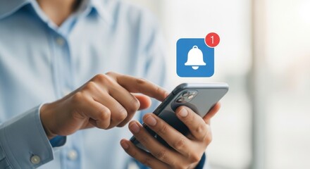 Person using a smartphone with a notification bell icon indicating an unread message or alert on the screen