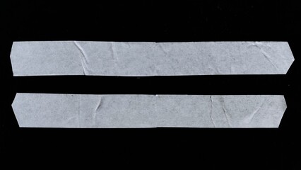 Fototapeta premium A set of blank white adhesive paper tape in rectangular shape isolated on black background with clipping path. The white paper looks vintage with wavy paper texture and wavy edges.