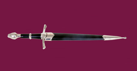 Dagger and scabbard isolated over a burgundy background