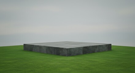 Fototapeta premium A sturdy, square concrete slab sits atop a gently rolling green hill under a soft, overcast sky, offering a versatile and grounded platform for various uses.