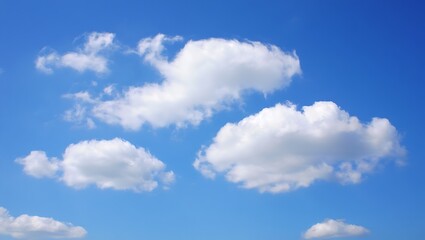 Fototapeta premium Photo of fluffy white cumulus clouds float serenely in a clear blue sky, creating a peaceful and idyllic scene of summer weather and natural beauty