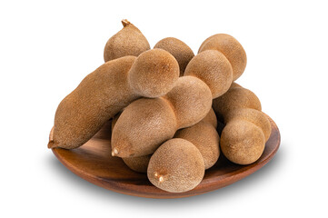 Pile of sweet Tamarind in wooden dish isolated on white background with clipping path.