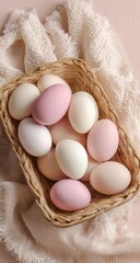Pastel-colored eggs nestled in a wicker basket atop a soft, textured fabric