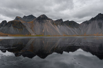 Vestrahorn black mountain with reflection, Iceland.