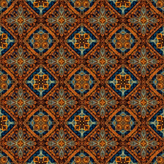 A rich seamless pattern showcases an intricate, tile-like geometric design in warm autumnal tones of orange, brown, and blue, perfect for decorative and textile projects.