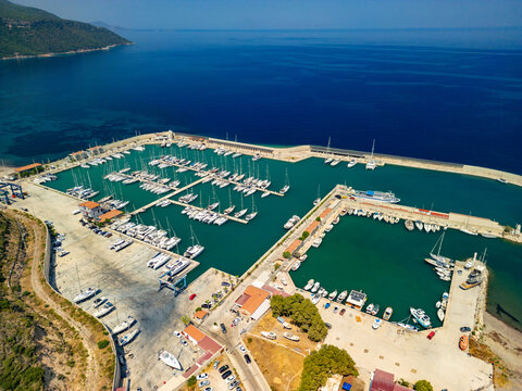 Aerial view of boats docked in Kormen Marina, where turquoise waters meet the land, framed by the deep blue sea, Datca, Mugla, T&Atilde;&frac14;rkiye.