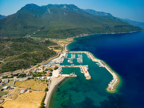 Aerial view of the Kormen Marina where turquoise waters meet the rugged coastline beneath the watchful gaze of the mountains, Datca, Mugla, T&Atilde;&frac14;rkiye.