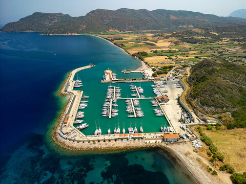 Aerial view of boats docked in Kormen Marina, the turquoise waters contrasting with the golden sands and verdant hills, Datca, Mugla, T&Atilde;&frac14;rkiye.