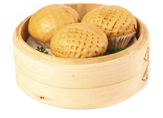 Canton style popped walnuts with brown sugar displayed in bamboo steamer on white background