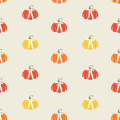 Seamless pattern with bright colorful pumpkins and bows on beige background. Designe for print, fabric, wallpaper, wrapping paper