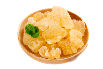 Handmade largegrain yellow rock candy on display with a fresh mint leaf accent