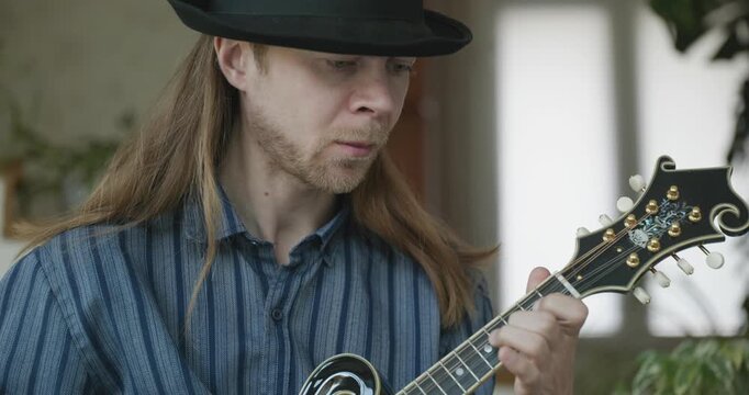 Male Musician Plays Mandolin. Caucasian Man Enjoys Playing Music 4K 10-bit