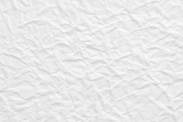 Obraz premium a close up view of a white crumpled texture that could be paper or fabric, filling the entire frame.