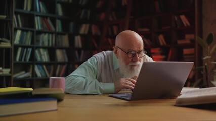 Senior professor reading bad news on laptop, lost file due to program issue