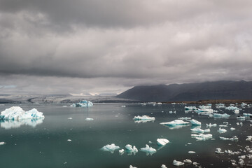 Icebergs Floating in Glacier Lagoon Under Overcast Sky