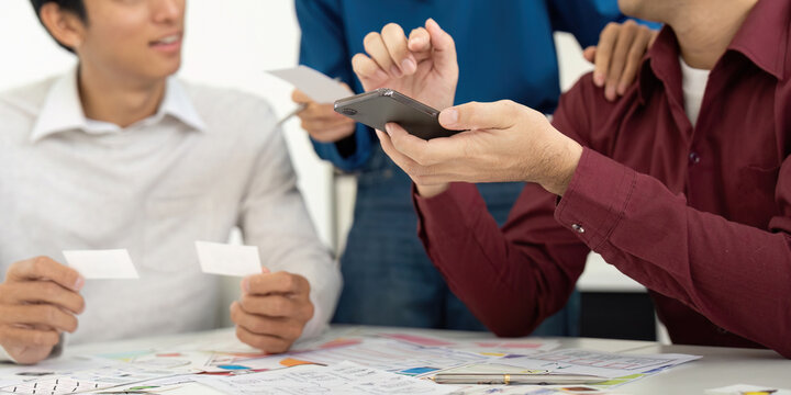 UX and UI Team Discussing Design Ideas with Smartphone