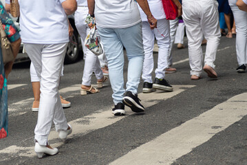 Obraz premium Half-body of unidentified people walking on the street wearing casual clothes.