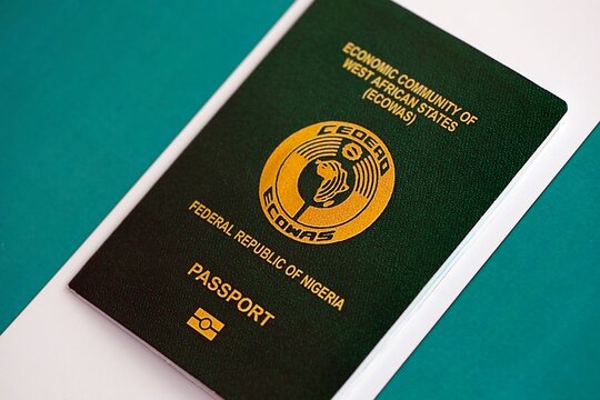 Nigerian passport on flag. The concept of citizenship