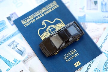 United Arab Emirates dirham currency money bills and car with passport. The concept of car ownership