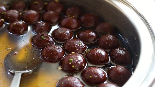 Gulab jamun or kala jaam an indian fried dessert dipped in sugar syrup
