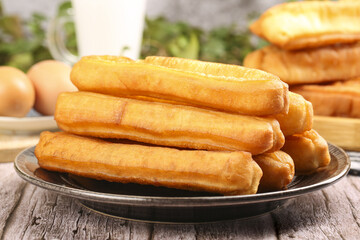 Crispy fritters served hot as a traditional breakfast treat at a bustling local cafe in the early morning