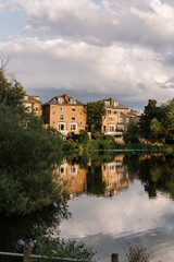 Fototapeta premium Reflections of buildings at a pond in Hampstead Heath, London