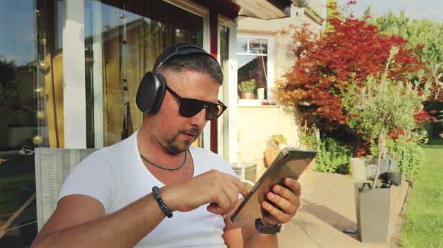 Man using tablet under soft light