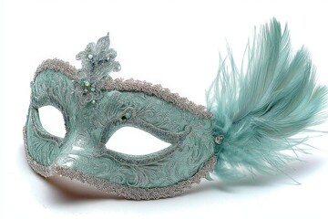 Beautiful teal masquerade mask decorated with feathers and intricate designs for festive occasions and celebrations
