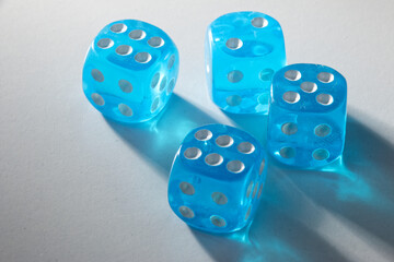 A random arrangement of blue dice and a puzzle cup, captured after the dice have been cast.