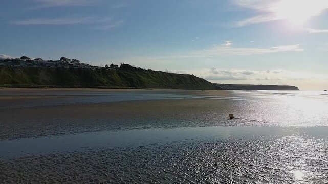 Scenic Drone Shot of Coastal Cliffs Revealed by Low Tide in Summer Light