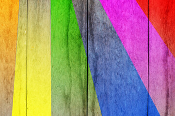 Multi color on wooden plank background.