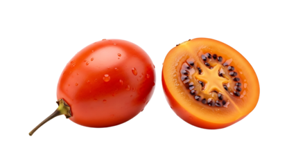 Fresh tamarillo duo Whole fruit with water droplets and halved fruit revealing starshaped core.