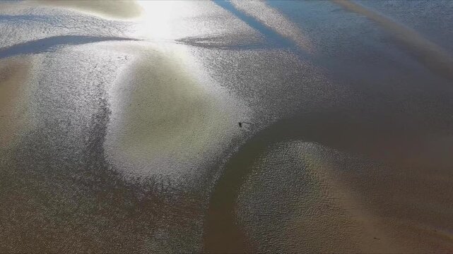 Abstract Patterns of Wet Sand and Reflected Sky at Low Tide - Drone Shot