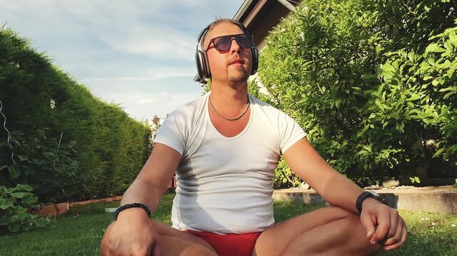 Man sitting and moving to music outdoors