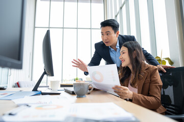 Two colleagues engage in discussion, working together on a project strong teamwork and cooperation. Their strategic brainstorming highlights a successful partnership built on trust and dedication.
