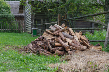 Firewood on green grass background. Select focus.