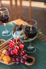 Red wine glasses and appetizers on the table.