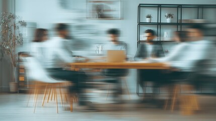 Blurred Motion Of A Business Team Sitting And Discussing At A Modern Office Meeting