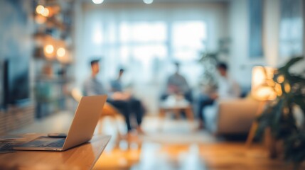 Person Working On Laptop In A Modern Office Or Living Room With Blurred People In Background