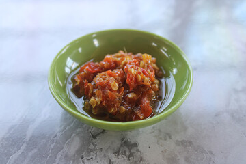 Spicy and Aromatic Indonesian Sambal Oelek in a Green Bowl on a Marble Table