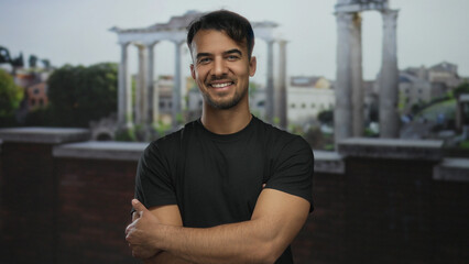 Fototapeta premium Young man smiling in front of ancient roman ruins in an outdoor city setting, showcasing historical architecture and urban lifestyle.