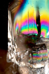 Beautiful close up of quartz crystal rock shard with reflective rainbow spiritual light